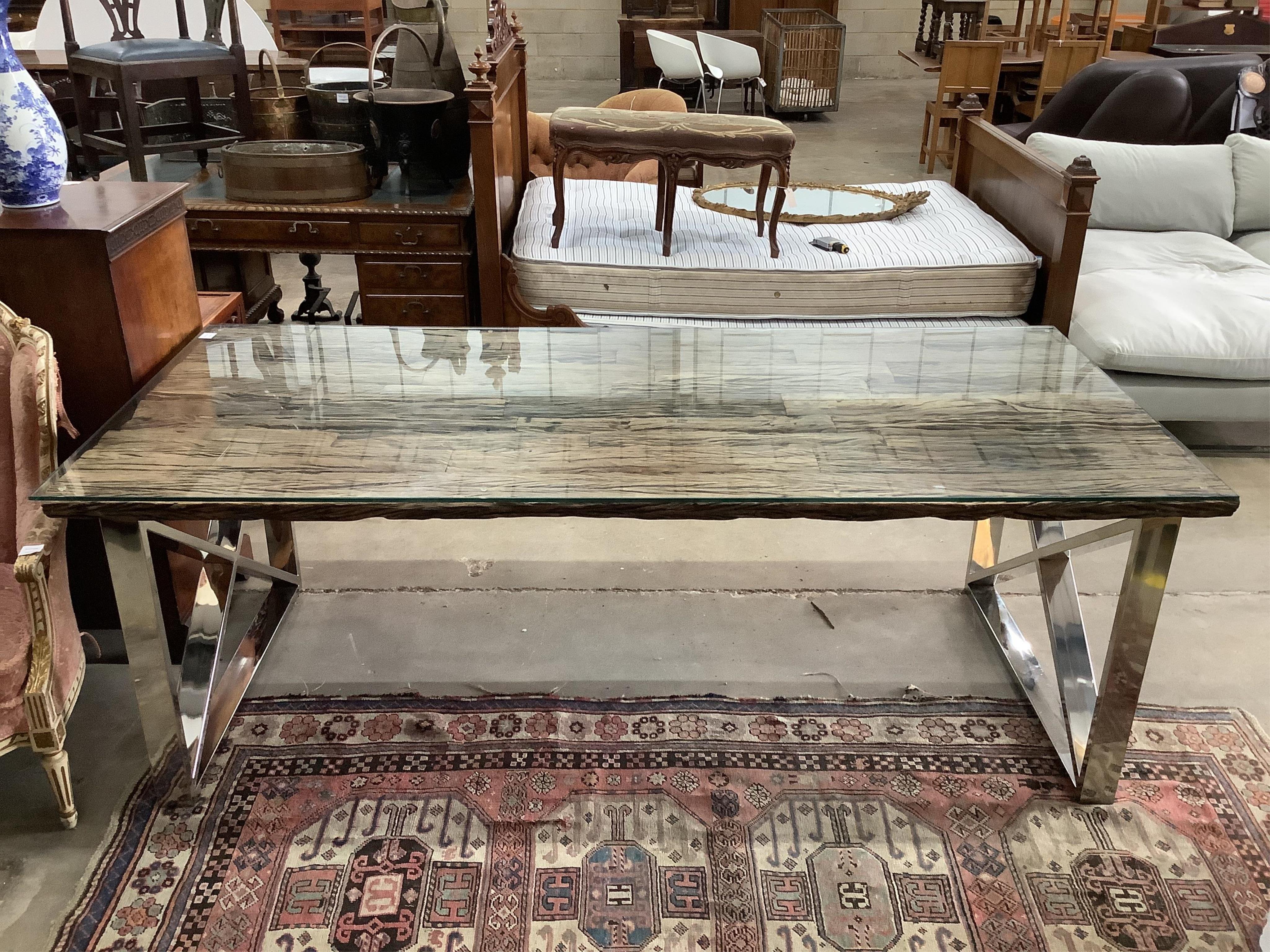 A Contemporary glass top weathered timber and chrome dining table, the top made from old train rail track woods, width 221cm, depth 102cm, height 77cm, and a set of six upholstered dining chairs. Condition - good